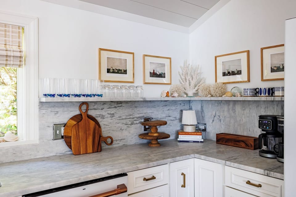 Detail of Carrera marble counters, backsplash, and shelf.
