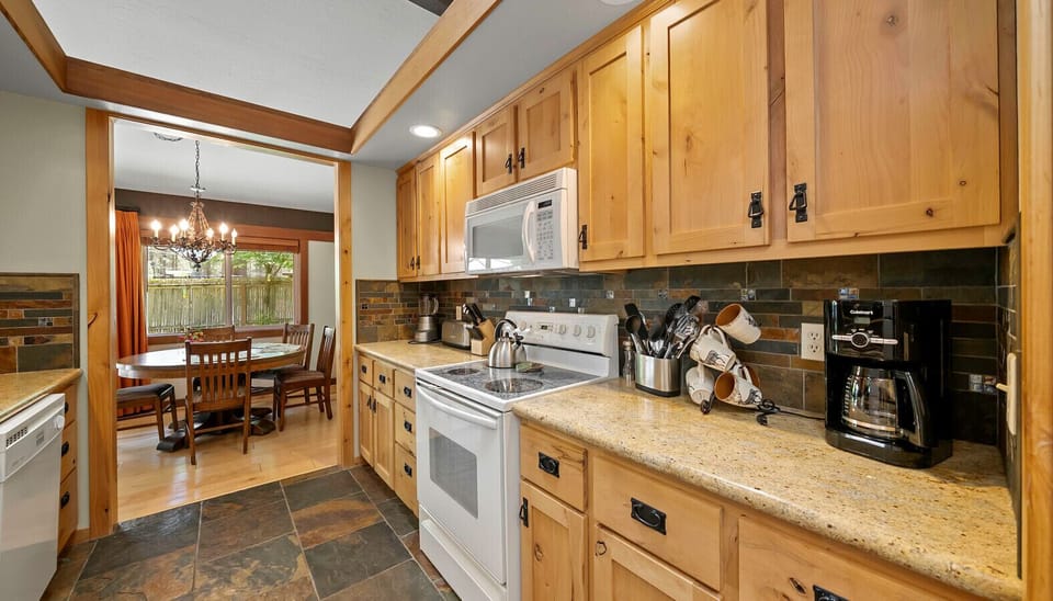 Custom cabinetry, granite countertops and slate flooring make for a gorgeous updated kitchen