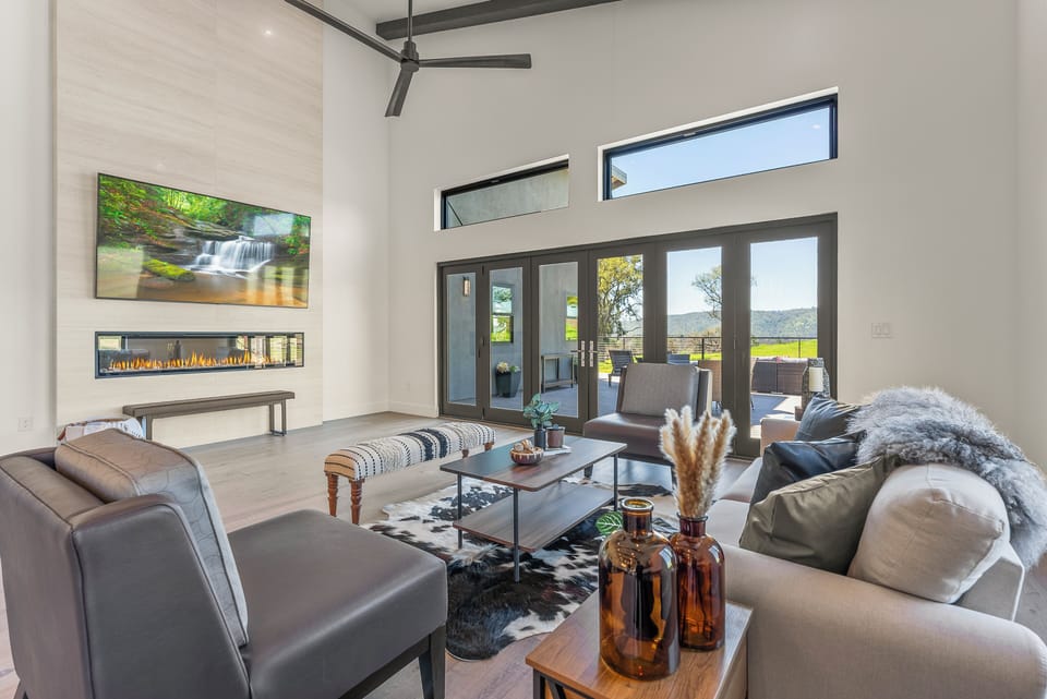 Great room with walls of windows, beautiful views and Smart TV.