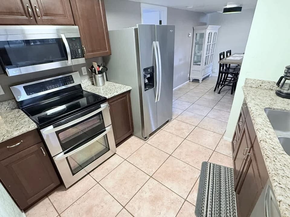 Functional and stylish, the kitchen features plenty of counter space and storage. Ideal for everyday cooking or hosting guests. It flows seamlessly into the dining area, making it easy to stay connected while you cook.