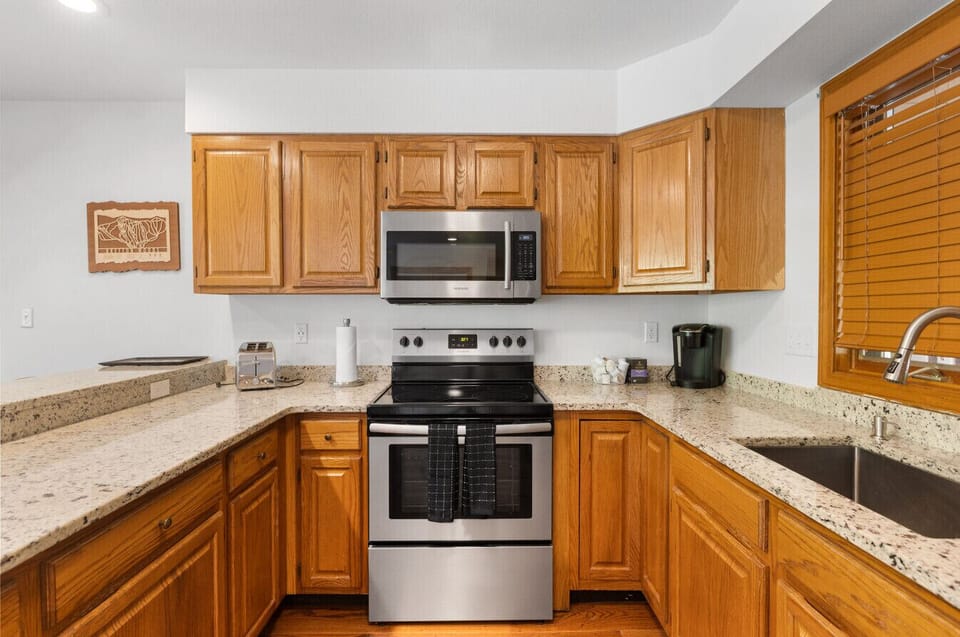 Open kitchen with new appliances and everything you need to entertain and cook.
