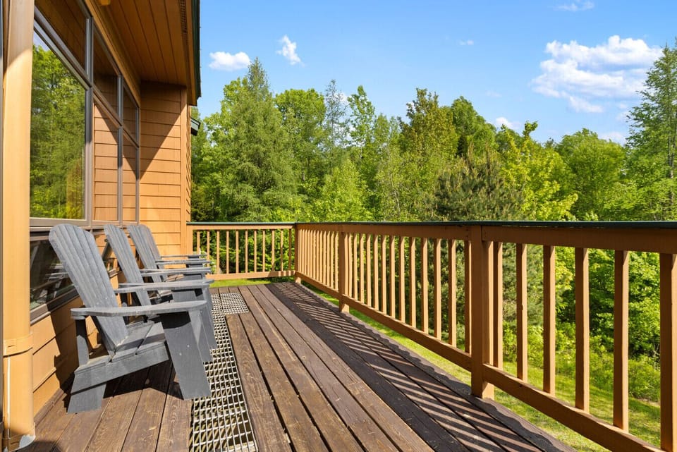 Step onto the deck sink into an Adirondack chair, and enjoy peaceful views of the surrounding trees and sky.