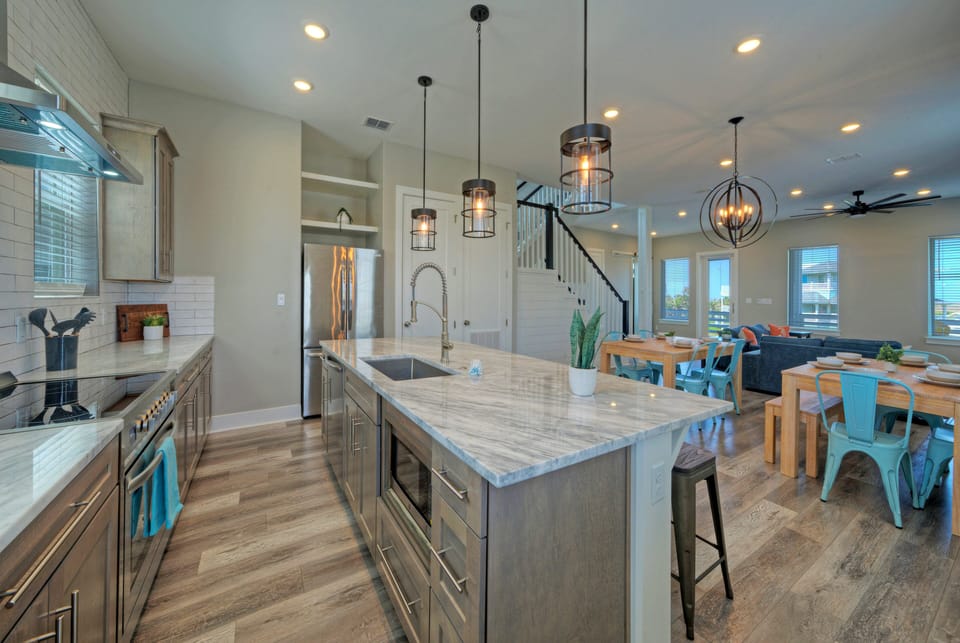 Kitchen view showcasing island with quartz countertops.