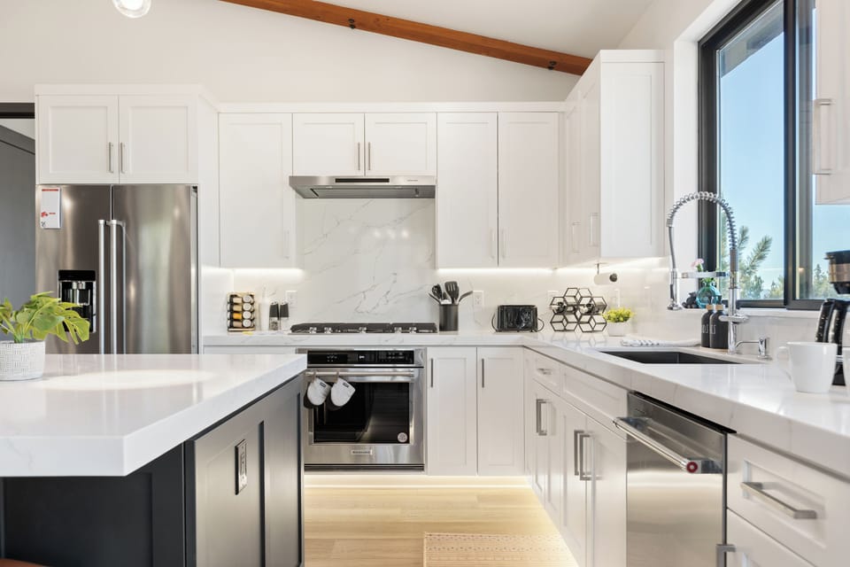 White cabinetry and stainless appliances.