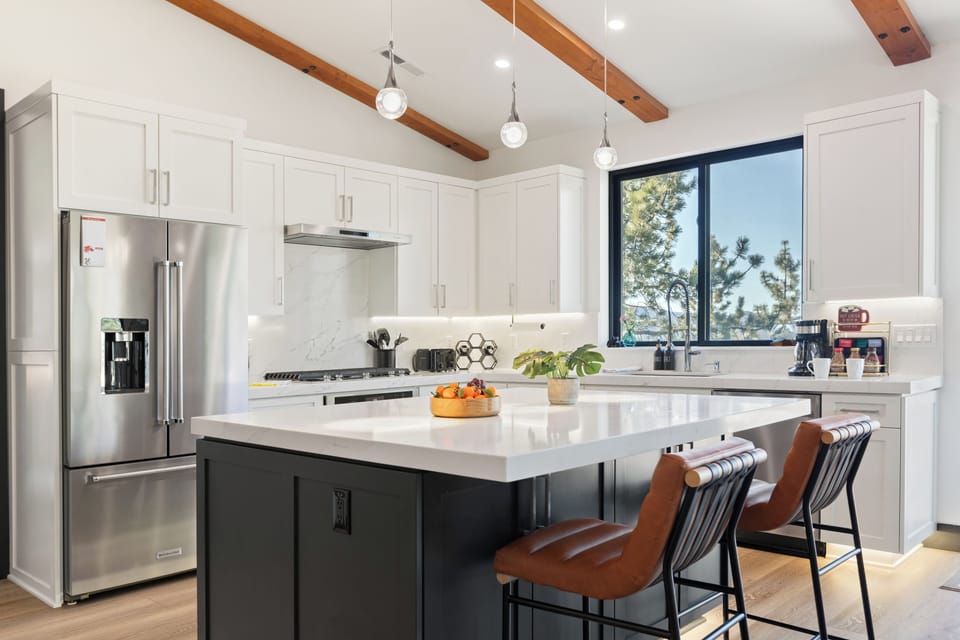 Large kitchen island with seating and elegant pendant lights.