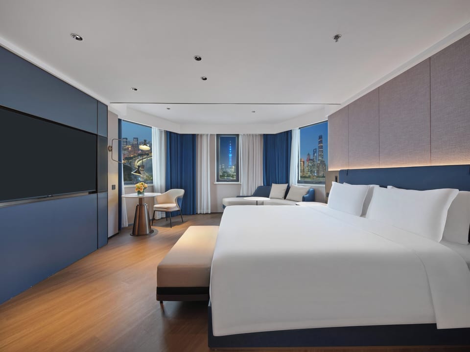 Panoramic view of the Bund,  one living room, one bedroom suite | Hypo-allergenic bedding, down comforters, memory foam beds, free minibar