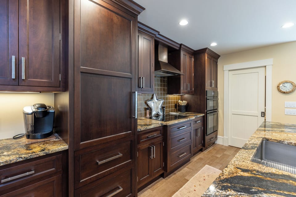 High-end appliances, double wall ovens, a wine refrigerator, and generous storage make cooking effortless,