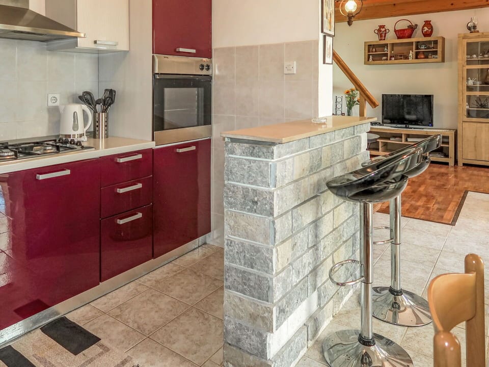 Furniture, Countertop, Flooring, Kitchen, Interior Design, Cabinetry, Wood, Kitchen Appliance, Floor, Major Appliance