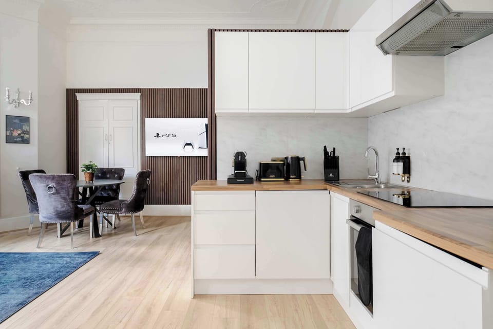 Full Kitchen | Make yourself at home in the fully equipped kitchen, ideal for any length of stay. With a washer, dryer and Nespresso machine, it offers all the essentials for a smooth and comfortable stay.
