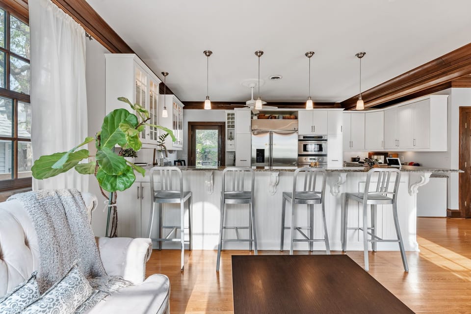 Your chef's paradise awaits with granite counters, stainless appliances, and cozy seating where you'll sip coffee while sunlight streams through beautiful windows.