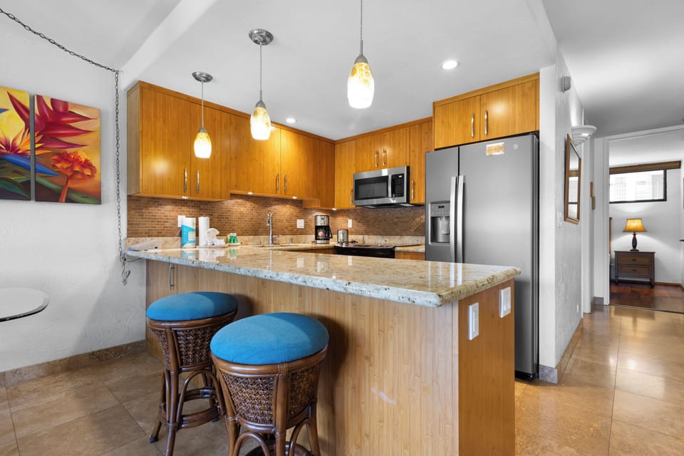 Your fully equipped kitchen features granite countertops, modern appliances, and a breakfast bar perfect for casual dining and entertaining.
