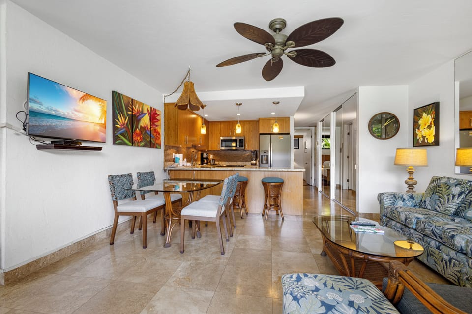 Relax in your open-concept living space with tropical décor, fully-equipped kitchen, and comfortable dining for six. The airy layout and coastal touches create your perfect island retreat.