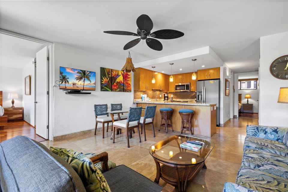 Unwind in your open-concept living space with tropical decor, comfy seating, a fully equipped kitchen, and coastal vibes that make you feel instantly at home.