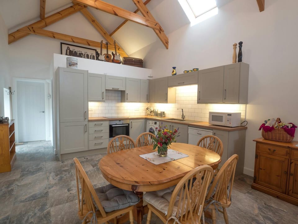 Kitchen and dining table and chairs and cabinets against the wall