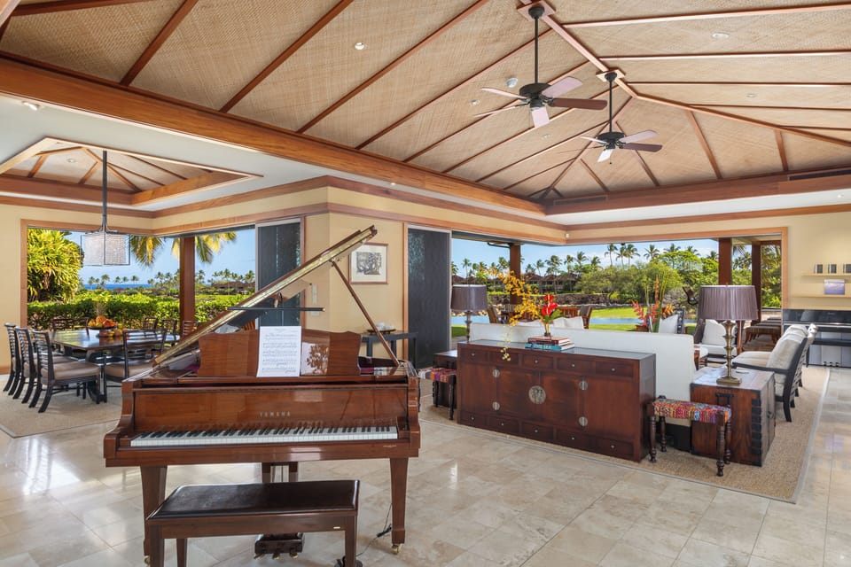 Grand piano and panoramic views in the great room—a luxury retreat infused with island sophistication.