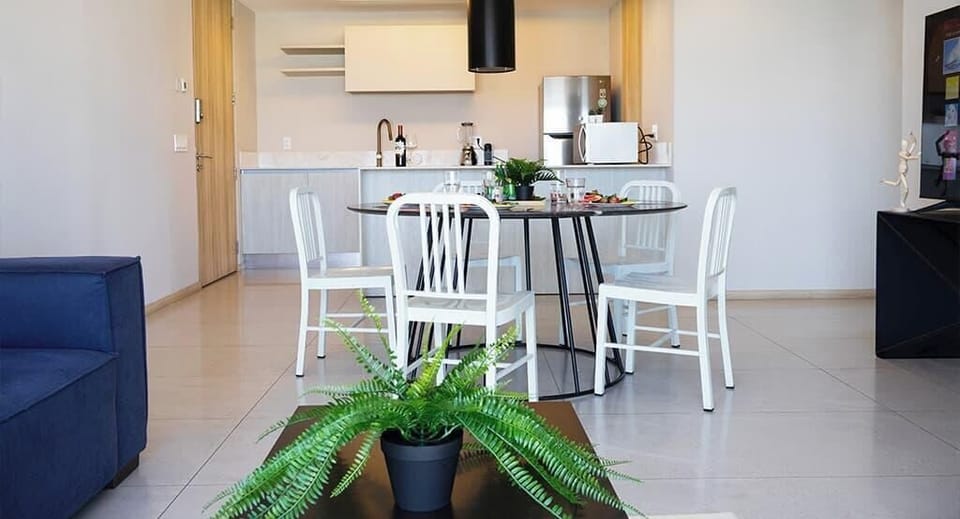 Bright open living space w/ dining table, sofa seating & natural light