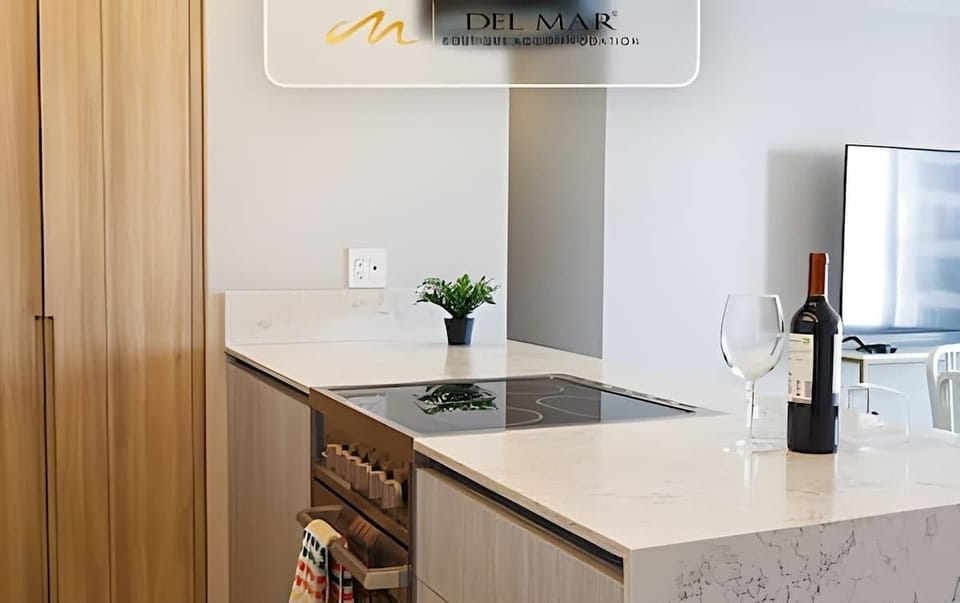 Kitchen counter w/ cooktop, wine & minimalist finishes