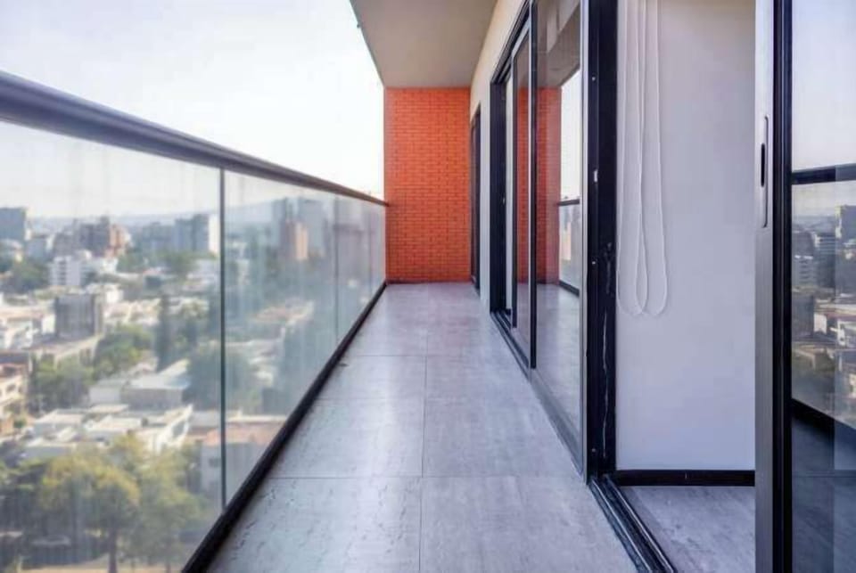 Open balcony walkway w/ skyline views & fresh air right outside the room