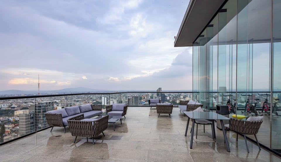 Shared rooftop terrace w/ lounge seating, an inviting spot to relax above the city skyline