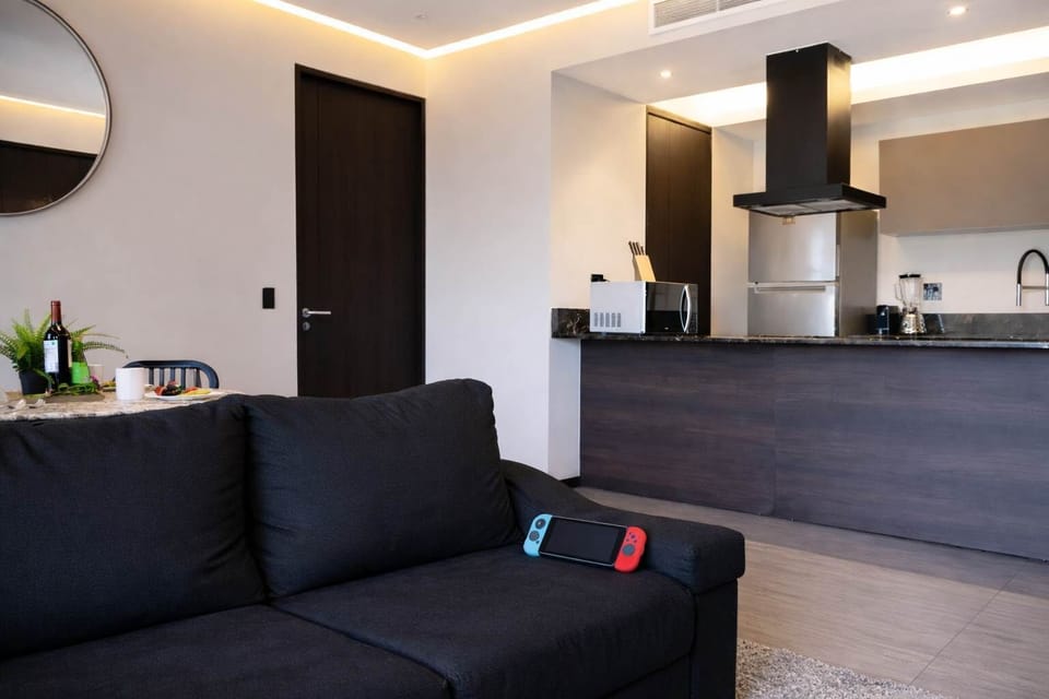 Open living area w/ sofa seating flowing into the kitchen space