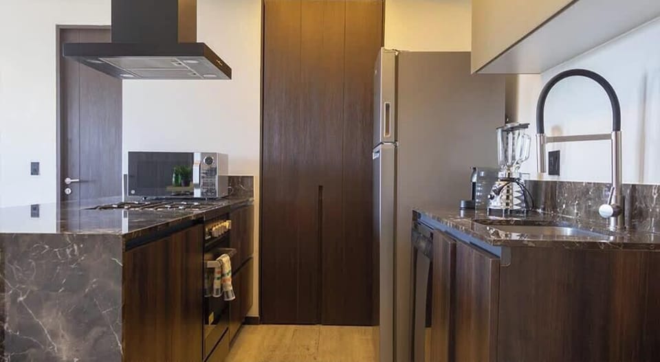 Modern kitchen w/ sleek wood cabinetry, sink & open layout for easy meal prep