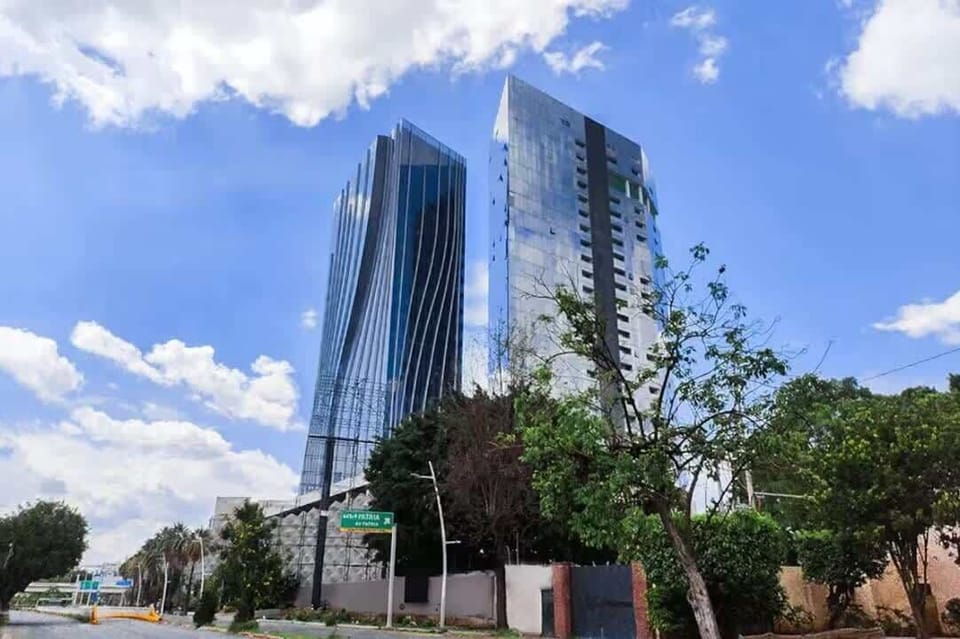 Striking exterior view of modern high-rise towers against a blue sky