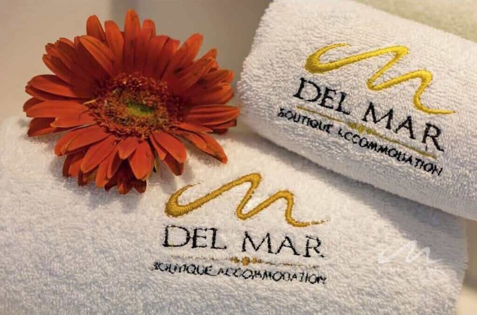 Fresh towels neatly arranged w/ a flower accent for a welcoming touch