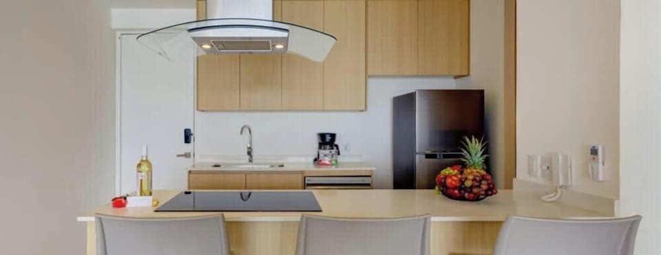 Modern kitchen island w/ bar seating, pendant lighting & open layout