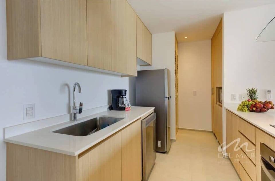 Bright kitchen w/ sleek cabinets, stove & long counter space for easy meal prep