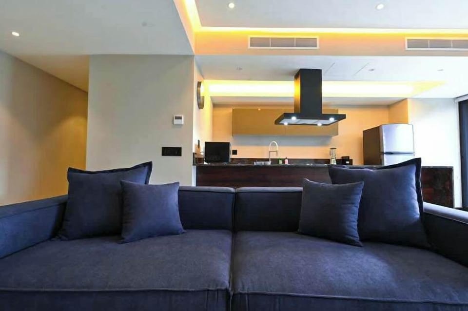 Inviting living room sofa beneath warm lighting, perfect for relaxing after a long day