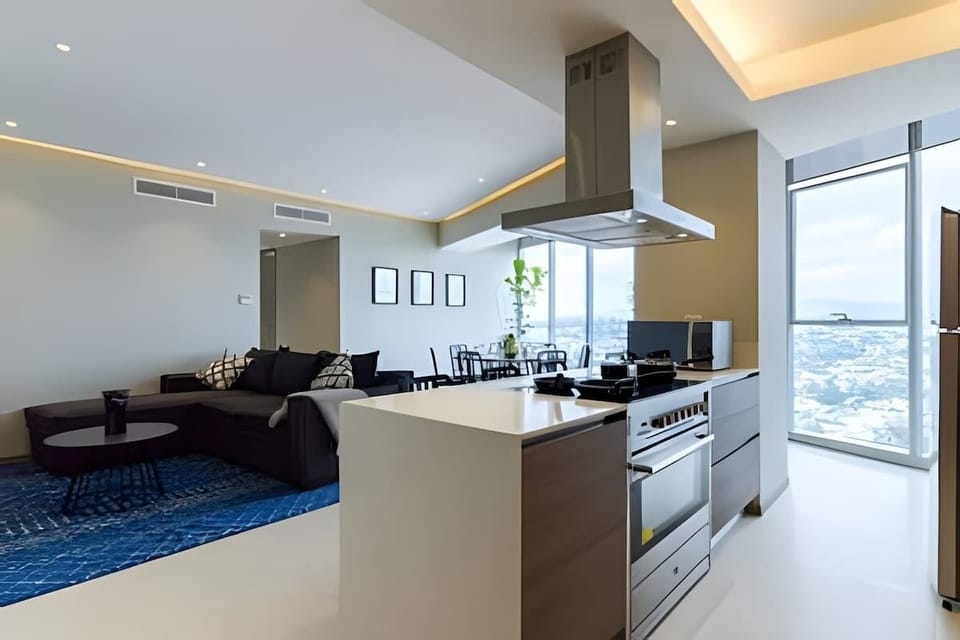 Modern kitchen w/ large island, sleek hood & open layout for cooking & gathering
