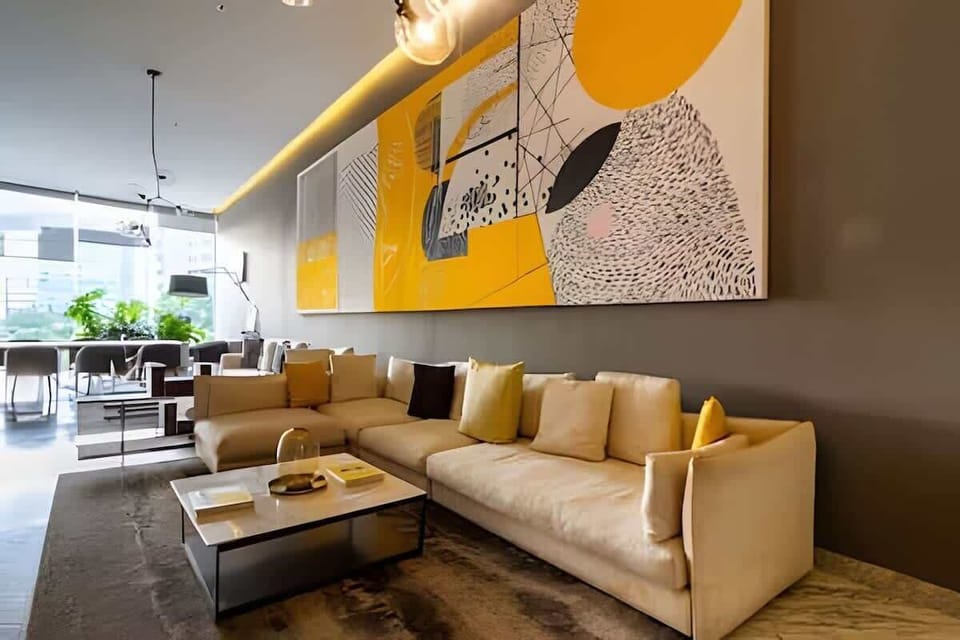 Common area: Shared lounge w/ plush sofa, bold mural wall & warm lighting for laid-back evenings indoors