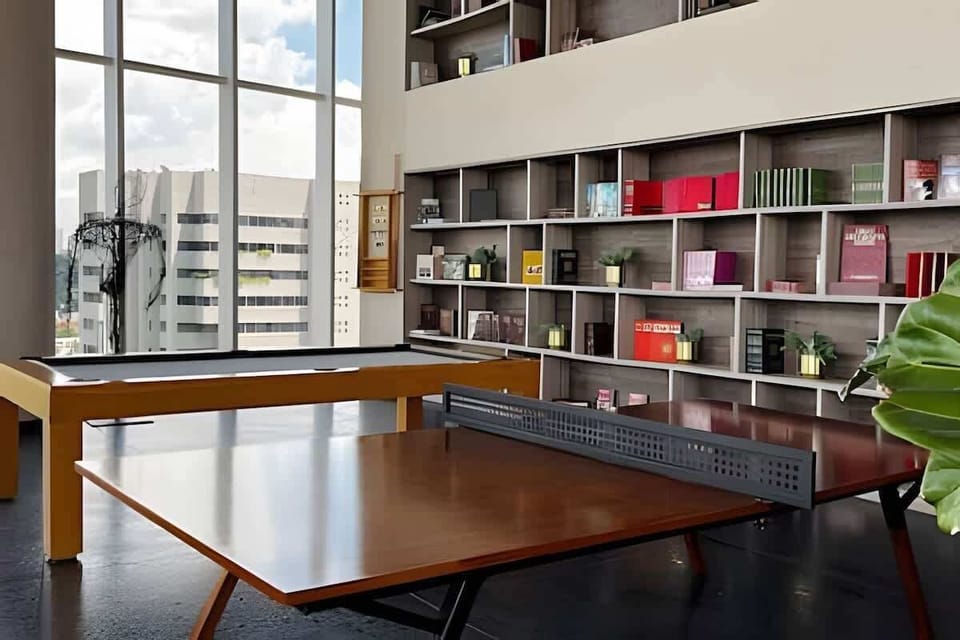 Common area: Library-style workspace w/ shelving & large windows for a bright place to read or work