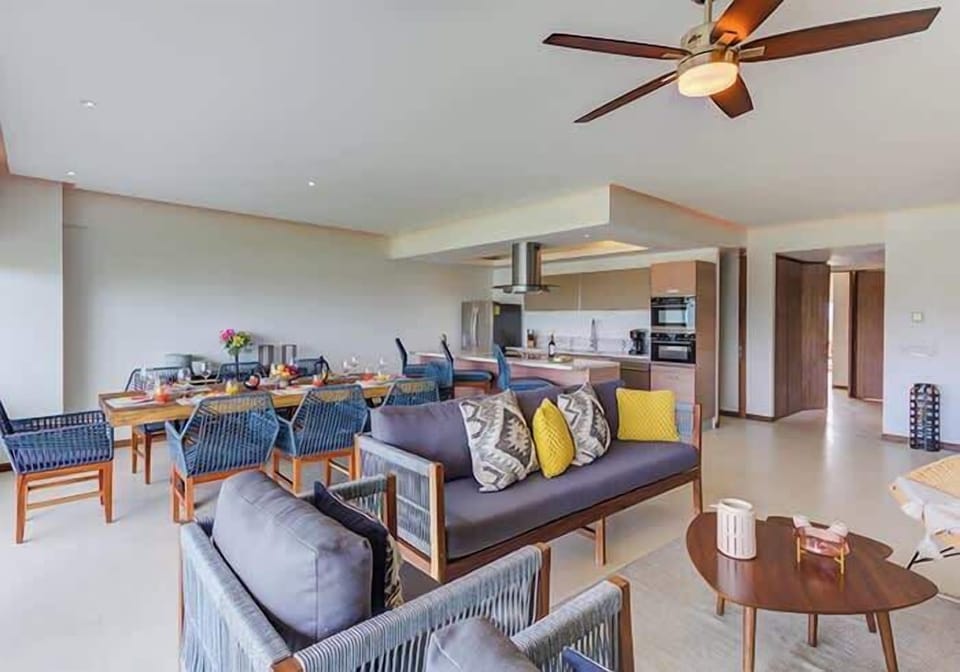 Open living area w/ plush seating & dining table, designed for easy group gatherings