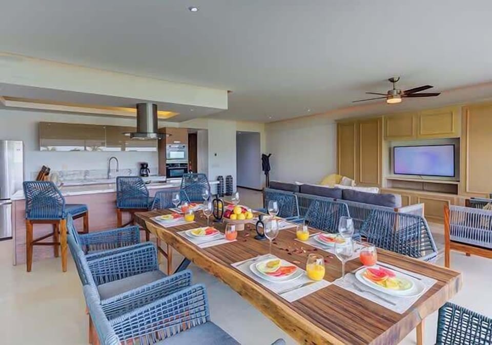 Spacious dining area w/ large table set for a shared meal, ideal for gathering w/ family & friends