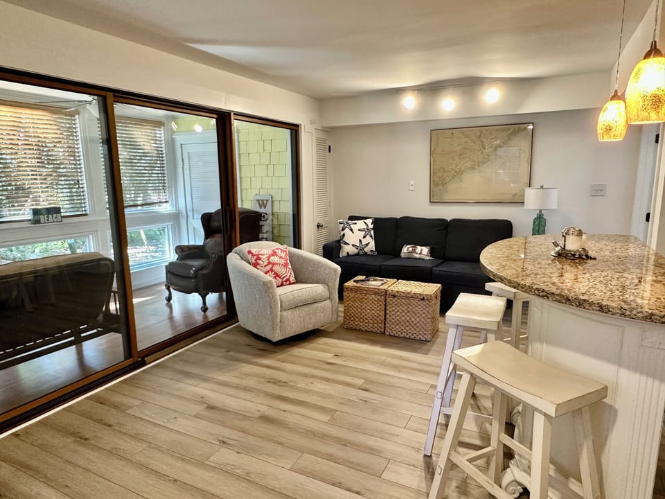 Comfortable living room connected to the sunroom.