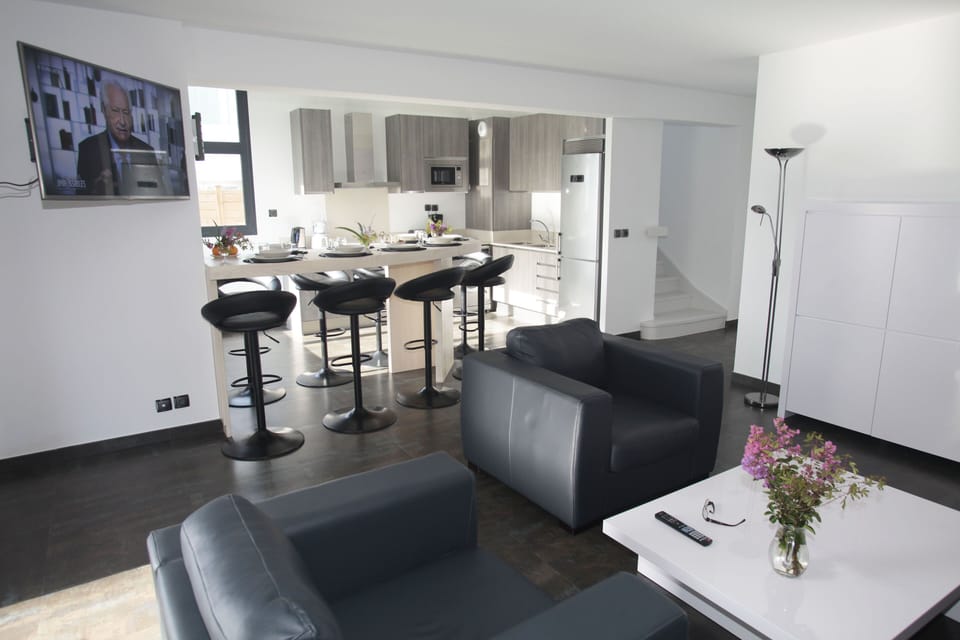 Bright and open living area with comfortable seating and access to the furnished terrace for seamless indoor-outdoor living.