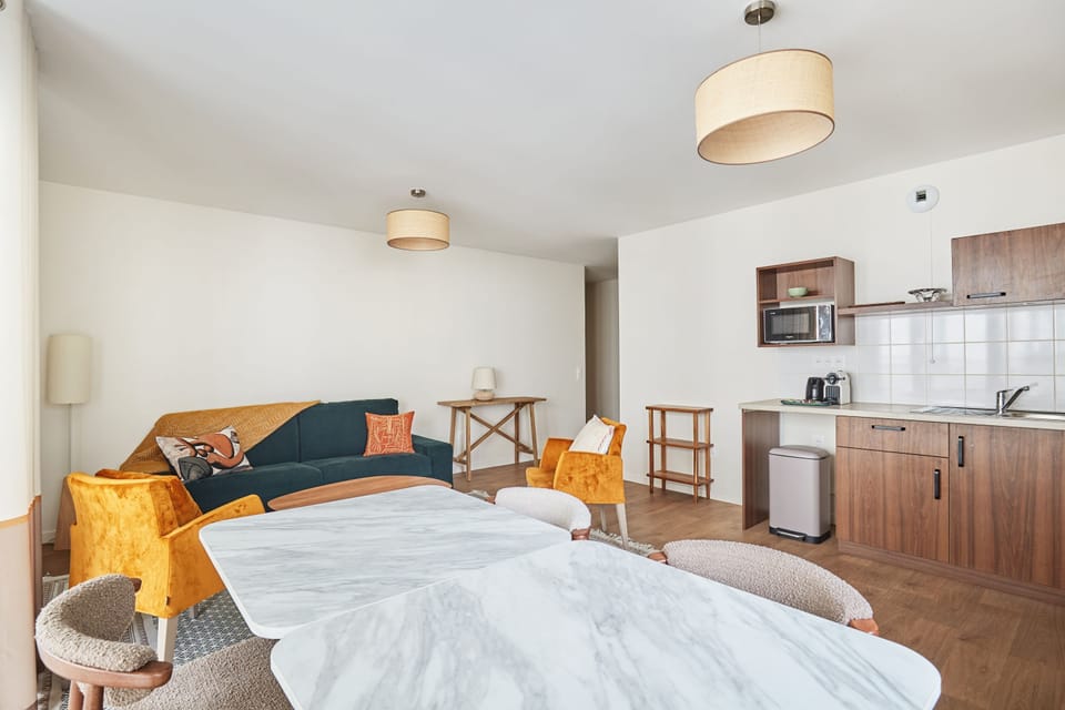 Open living space with stylish design and direct connection to both kitchen and dining areas.