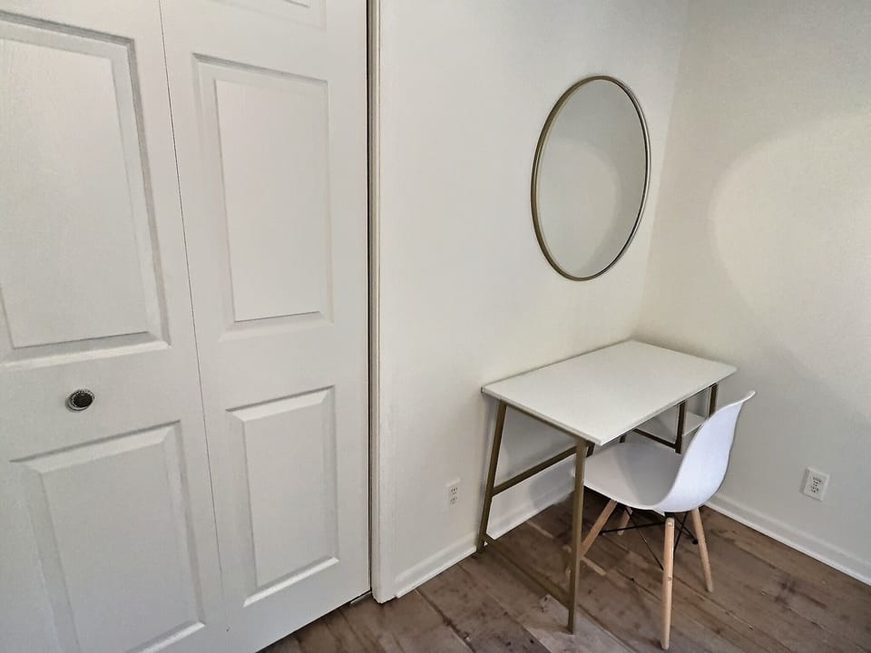 Spacious secondary bedroom w/ queen size bed, desk/work space and closet.