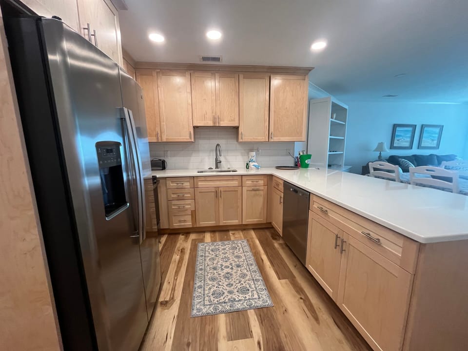 Freshly updated kitchen with clean lines and modern finishes. The open layout flows seamlessly into the living and dining areas—perfect for relaxed coastal stays.