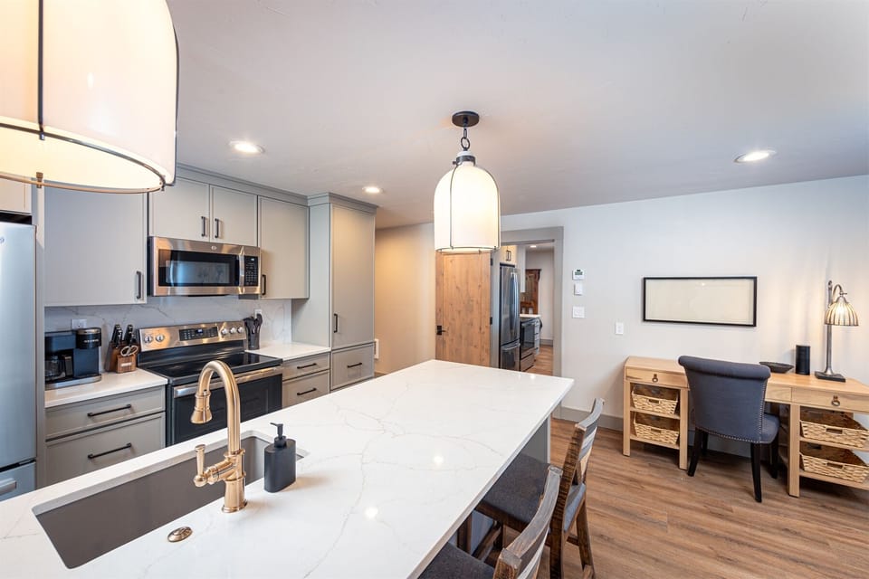 The living area offers a dedicated work space for those working remotely | Main Level