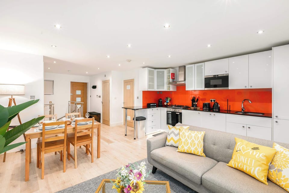 Bright open-plan living, kitchen and dining area, filled with natural light to create a spacious, warm and welcoming atmosphere