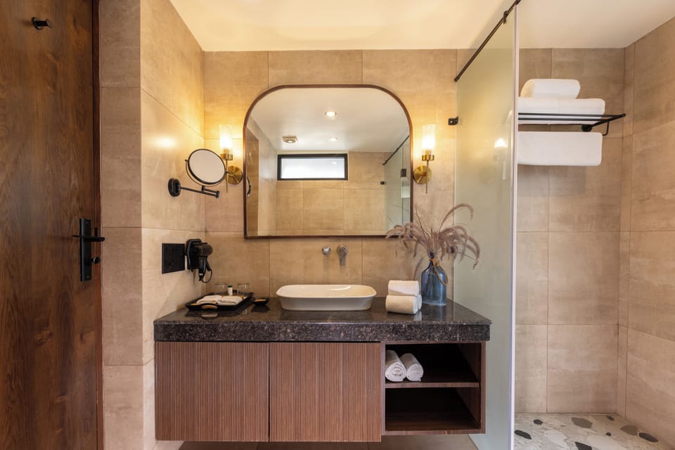 Junior Villa, Resort View | Bathroom | Shower, slippers, towels, soap