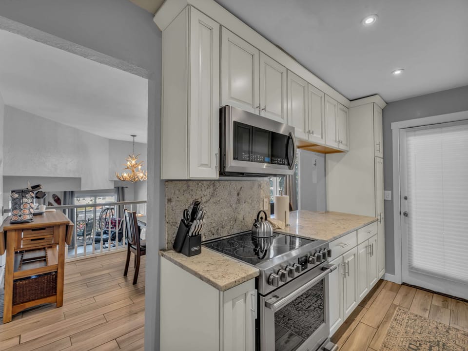 Kitchen: Main floor, drip coffee maker, Keurig, toaster, cooking utensils, tableware