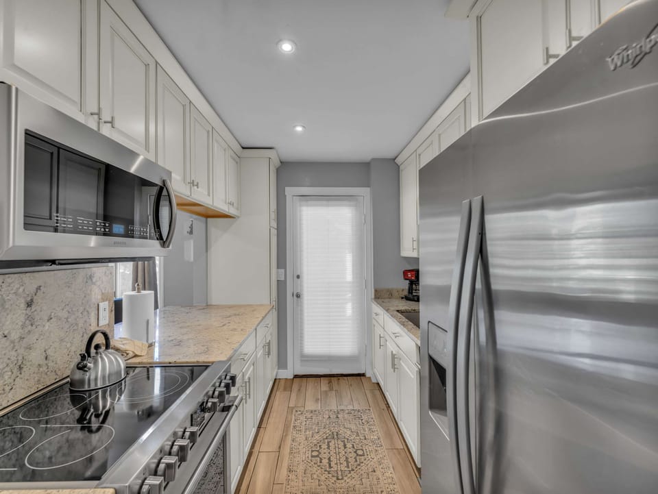 Kitchen: Main floor, drip coffee maker, Keurig, toaster, cooking utensils, tableware