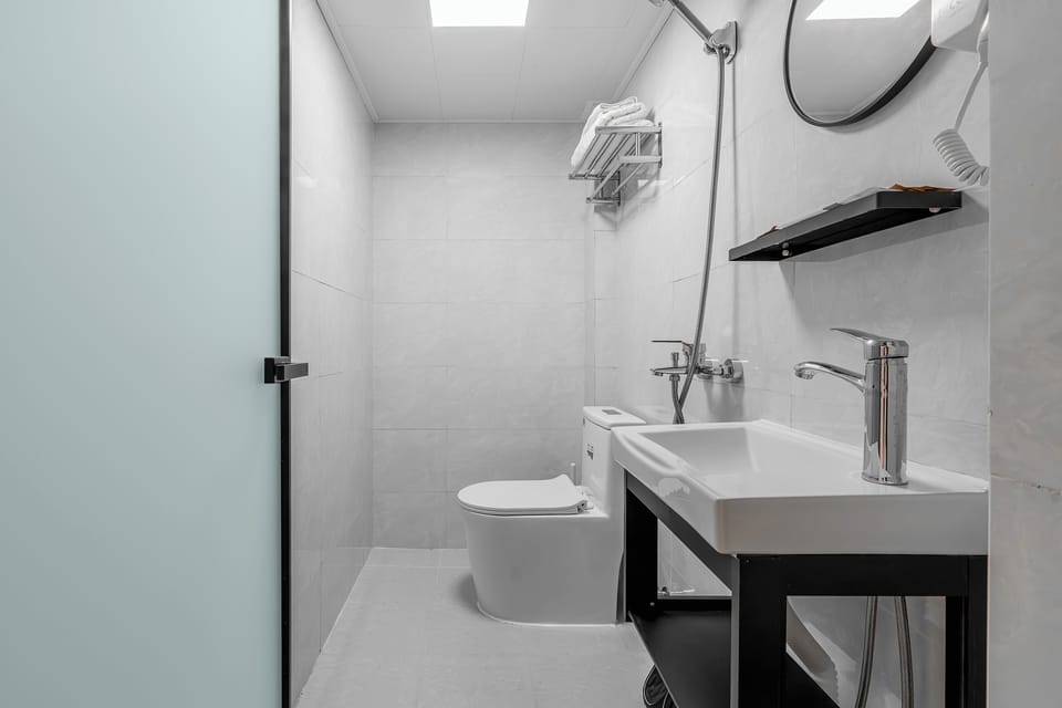 Shower, hair dryer, slippers, towels