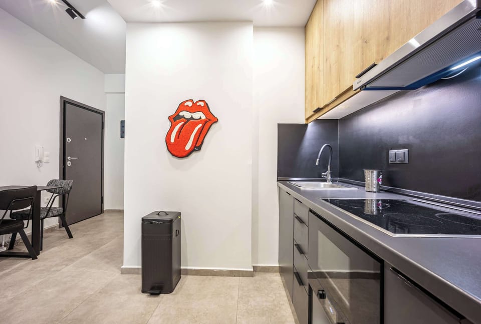 A fun pop-art touch and bright lighting make this kitchen feel stylish and inviting. Guests appreciate the easy layout and quick access from the entrance.