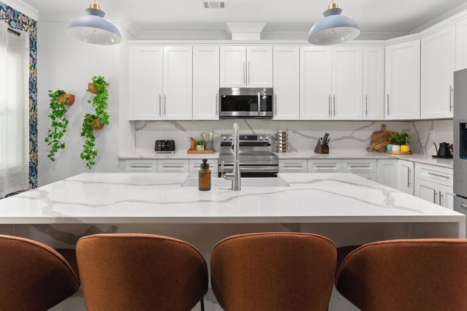 Whip up gourmet meals in this sleek, fully stocked kitchen—complete with luxe countertops, modern appliances, and serious style.