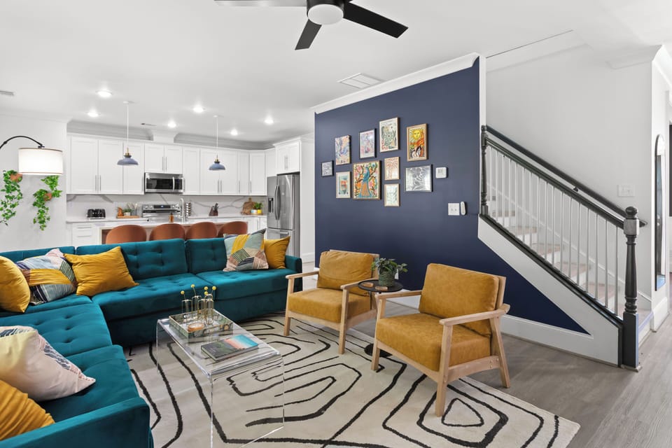 Relax in this vibrant designer living room where style meets comfort. From the statement wall to the plush velvet seating, every corner is Insta-worthy.