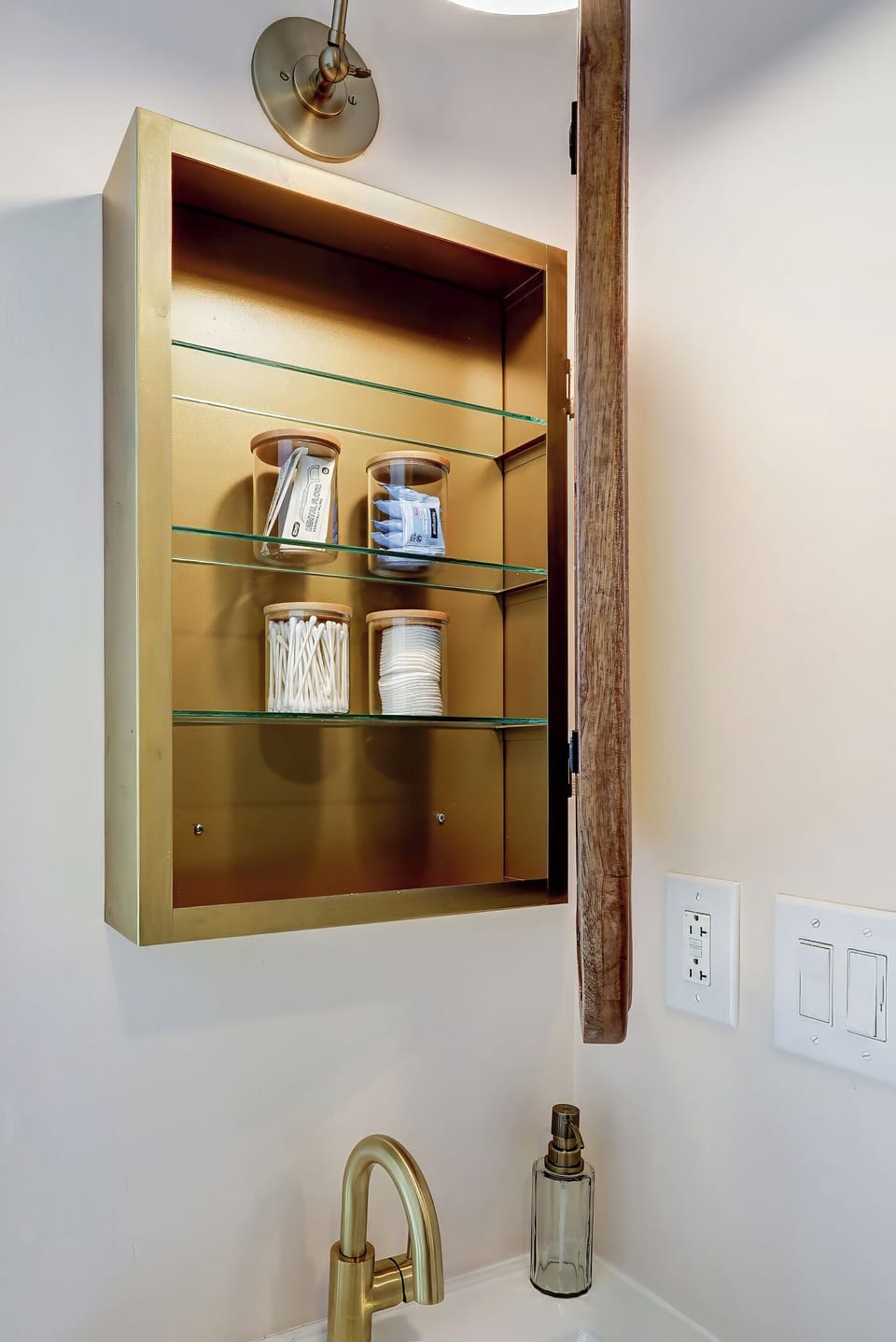 Medicine cabinet with complimentary q tips, cotton rounds, makeup wipes and flossers